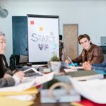 A group of young professionals brainstorming ideas in a startup office setting.